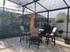 Screened patio area featuring a dining table with chairs perfect for outdoor entertaining at 3034 Boating Blvd, Kissimmee, FL 34746