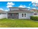 Home with a screened patio and grassy backyard at 3074 White Horse Ct, Kissimmee, FL 34746