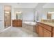 Bathroom with double vanity, soaking tub, and shower at 3074 White Horse Ct, Kissimmee, FL 34746