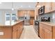 Modern kitchen with light wood cabinets, granite counters, and stainless steel appliances at 3074 White Horse Ct, Kissimmee, FL 34746