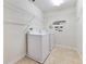 Laundry room with washer, dryer and ample shelving at 3074 White Horse Ct, Kissimmee, FL 34746