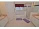Bathroom with double sinks, a soaking tub, and a shower at 4626 Cumbrian Lakes Dr, Kissimmee, FL 34746