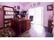 Home office with built-in desk and shelves, hardwood floors at 4626 Cumbrian Lakes Dr, Kissimmee, FL 34746