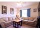 Living room with light beige sectional sofa and wood coffee table at 4626 Cumbrian Lakes Dr, Kissimmee, FL 34746