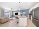 Open concept kitchen with island, stainless steel appliances, and living room view at 4816 Memories Ln, Kissimmee, FL 34746
