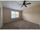 Bright bedroom with carpeted floor, ceiling fan, and large window at 6660 S Goldenrod Rd # 126B, Orlando, FL 32822