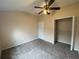 Well-lit bedroom with carpeted floor, ceiling fan, and walk-in closet at 6660 S Goldenrod Rd # 126B, Orlando, FL 32822