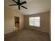 Main bedroom with carpet, ceiling fan, and access to en-suite bathroom at 6660 S Goldenrod Rd # 126B, Orlando, FL 32822