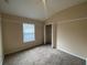 Spacious bedroom with carpeted floor, ceiling fan, and walk-in closet at 6660 S Goldenrod Rd # 126B, Orlando, FL 32822