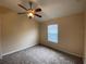 Bright bedroom with carpeted floor, ceiling fan, and window at 6660 S Goldenrod Rd # 126B, Orlando, FL 32822