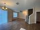 Spacious living room with hardwood floors, staircase, and chandelier at 6660 S Goldenrod Rd # 126B, Orlando, FL 32822