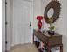 Elegant entryway with console table and a large sunburst mirror at 7509 Mourning Dove Cir # 304, Reunion, FL 34747