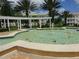 Community fountain with pergola and palm trees at 7509 Mourning Dove Cir # 304, Reunion, FL 34747