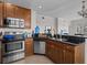 Modern kitchen featuring stainless steel appliances and dark wood cabinets at 7509 Mourning Dove Cir # 304, Reunion, FL 34747