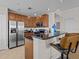 Modern kitchen with stainless steel appliances and breakfast bar at 7509 Mourning Dove Cir # 304, Reunion, FL 34747