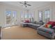 Spacious living room with sectional sofa and access to balcony at 7509 Mourning Dove Cir # 304, Reunion, FL 34747