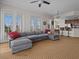 Open living area with sectional sofa and views of the kitchen at 7509 Mourning Dove Cir # 304, Reunion, FL 34747