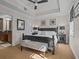 Bright main bedroom with a king-size bed and en-suite bathroom at 7509 Mourning Dove Cir # 304, Reunion, FL 34747