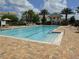 Community pool with plenty of lounge chairs at 7509 Mourning Dove Cir # 304, Reunion, FL 34747