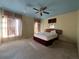Spacious bedroom with carpeted floors, large windows, and ceiling fan at 869 Colville Dr, Kissimmee, FL 34759