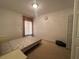 Simple bedroom with double bed, window, and closet at 869 Colville Dr, Kissimmee, FL 34759