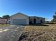 One-story house with a garage and a spacious yard at 869 Colville Dr, Kissimmee, FL 34759