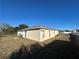 Side view of house showing a mostly clear yard at 869 Colville Dr, Kissimmee, FL 34759