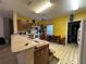 Kitchen with wood cabinets, white appliances, and a breakfast bar at 869 Colville Dr, Kissimmee, FL 34759