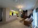 Bright living room with open kitchen view, comfy couch, and a ceiling fan at 869 Colville Dr, Kissimmee, FL 34759