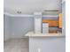 Open kitchen with light wood cabinets, breakfast bar, and gray walls at 8848 Villa View # 106, Orlando, FL 32821