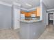 Kitchen with light wood cabinets, white appliances, and a breakfast bar at 8848 Villa View # 106, Orlando, FL 32821