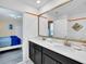 Bathroom with double vanity, large mirror, and view of bedroom at 9194 Sommerset Hills Dr, Davenport, FL 33896