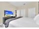 Bright bedroom with king-size bed and flat-screen TV at 9194 Sommerset Hills Dr, Davenport, FL 33896