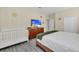 Bedroom with king-size bed, crib, and flat-screen TV at 9194 Sommerset Hills Dr, Davenport, FL 33896