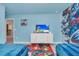 Two twin beds in a Marvel-themed bedroom with mural and TV at 9194 Sommerset Hills Dr, Davenport, FL 33896