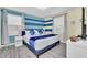 King-size bed, blue and white color scheme, and wood-look floors at 9194 Sommerset Hills Dr, Davenport, FL 33896