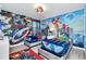 Two twin beds in a Marvel-themed bedroom with mural and themed bedding at 9194 Sommerset Hills Dr, Davenport, FL 33896
