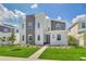 Two-story modern home with stone accents and landscaped lawn at 9194 Sommerset Hills Dr, Davenport, FL 33896