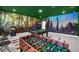 Game room features a pool table, foosball, and dinosaur mural at 9194 Sommerset Hills Dr, Davenport, FL 33896