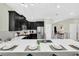 Modern kitchen island with seating and white countertop at 9194 Sommerset Hills Dr, Davenport, FL 33896