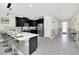 Open concept kitchen with island seating and stainless steel appliances at 9194 Sommerset Hills Dr, Davenport, FL 33896