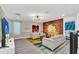 Spacious living room with scenic wall mural and comfortable seating at 9194 Sommerset Hills Dr, Davenport, FL 33896