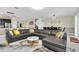 Open concept living room with sectional sofa and large TV at 9194 Sommerset Hills Dr, Davenport, FL 33896