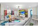 Open living space featuring a large TV and comfortable sofas at 9194 Sommerset Hills Dr, Davenport, FL 33896