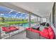 Relaxing covered patio with pool, spa, lounge chairs, and seating area at 9194 Sommerset Hills Dr, Davenport, FL 33896