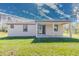 View of a backyard featuring a covered patio area with tile flooring and sliding glass doors at 9505 Luna Dr, St Cloud, FL 34773