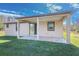 Shot of a cozy covered backyard patio featuring tile flooring and glass sliding doors at 9505 Luna Dr, St Cloud, FL 34773