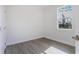 Bright bedroom with wood-look floors, white walls, and a window providing ample natural light at 9505 Luna Dr, St Cloud, FL 34773