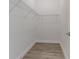 Walk-in closet features wire shelving and wood-style flooring, providing ample storage in an organized space at 9505 Luna Dr, St Cloud, FL 34773