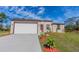 Charming single-story home with a well-manicured lawn, tidy landscaping, and a driveway at 9505 Luna Dr, St Cloud, FL 34773